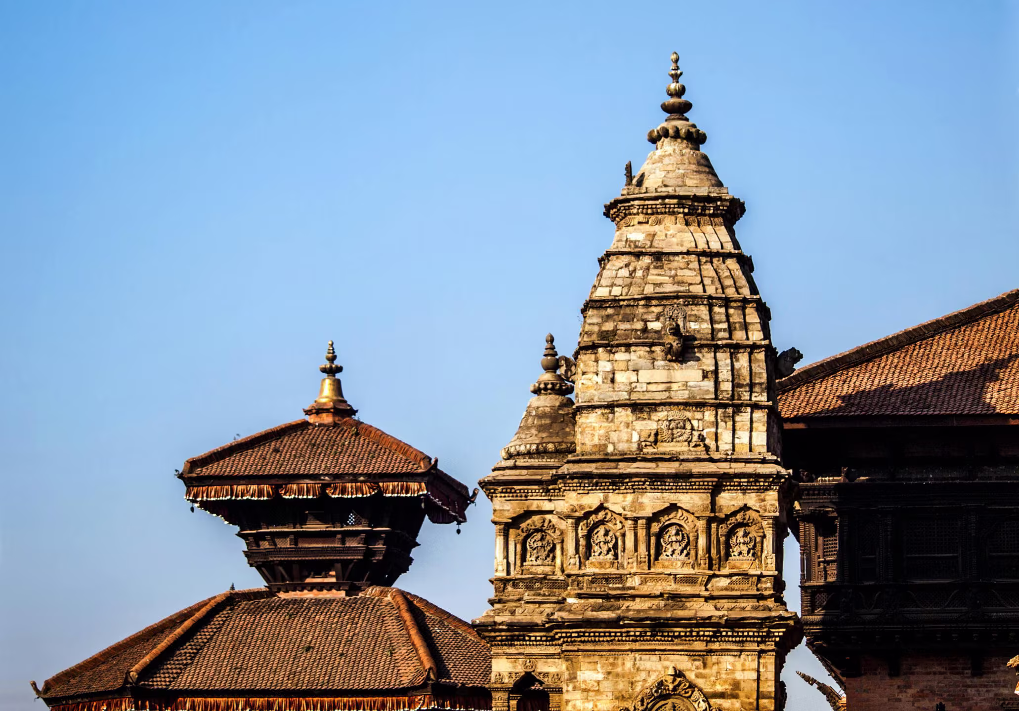 Tiered pagoda roofs rising over a Durbar Square